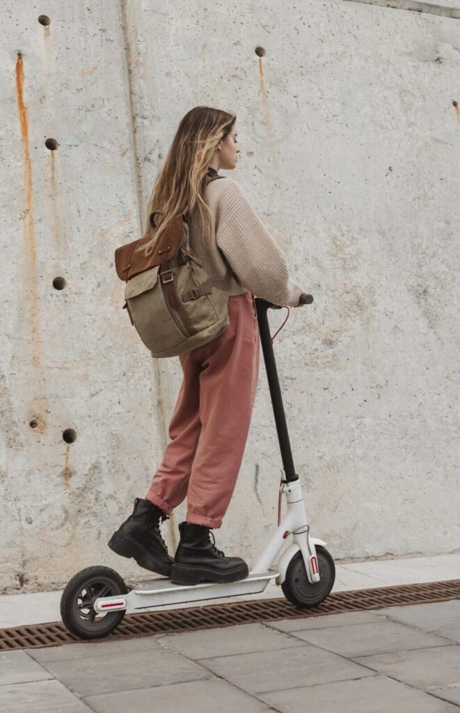 young woman riding electric scooter scaled e1750855740319